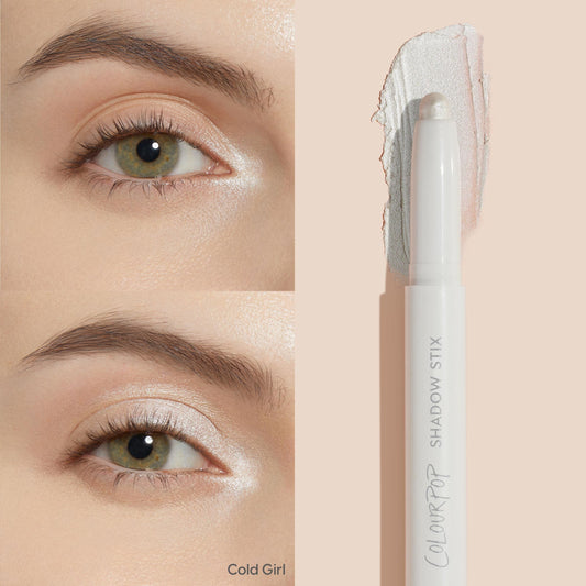 ColourPop Shadow Stix in Cold Girl highlighting eyelids - creamy twist-up stick swipes a frosty pearl shimmer across the lid and inner corner, shown on an eye with a side swatch and the white pen-style Shadow Stix packaging.
