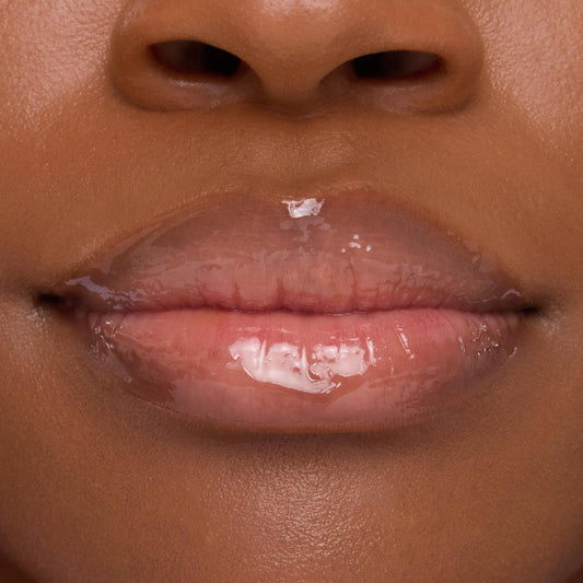 Lips wearing ColourPop Lip Mask in Strawberry Milk, gleaming with a sheer pink, high-shine finish in a tight close-up that emphasizes smooth, hydrated texture.