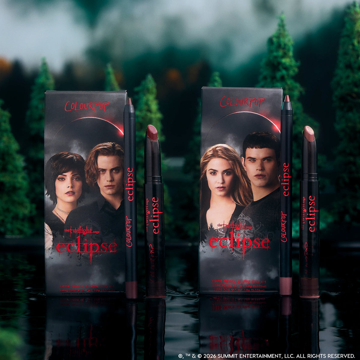 ColourPop Twilight Immortal Kiss Lippie Stix Duo stands upright on a reflective lake surface, with Eclipse-themed character boxes and matching deep nude and berry lip pencils and sticks framed by a dark, misty forest backdrop.