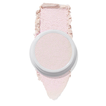 ColourPop Monster Super Shock Highlighter shown in an open white pot with a broad smear swatch behind it, revealing a silky pale pink, iridescent pearl glow, isolated on a clean white background.