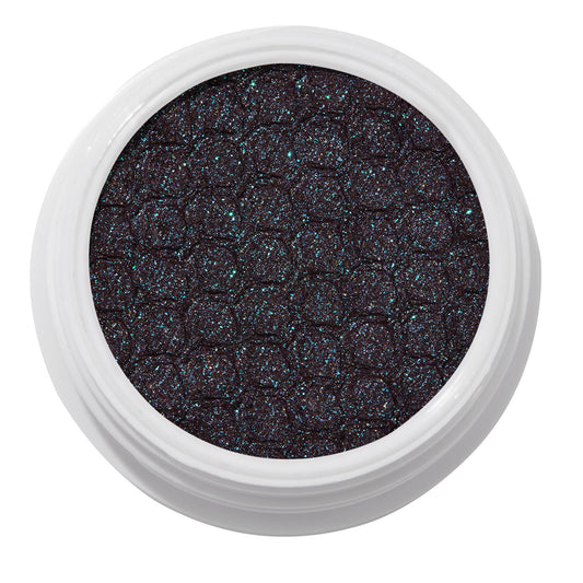 ColourPop Bae Super Shock Shadow shimmering in a white round pot, a deep plum-black cream eyeshadow packed with teal and blue microglitter and a quilted texture, shown close-up on a clean white background.