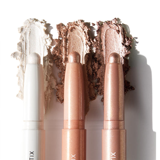 Three ColourPop Shadow Stix Metallic Neutrals swatched side by side, displaying creamy high-shine payoff - icy pearl, champagne peach, and bronze taupe - twist-up eyeshadow sticks with rounded tips on a clean white background.