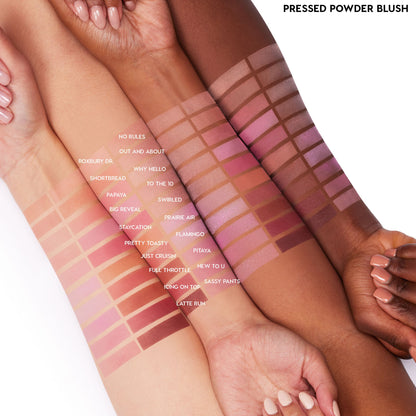 New to U ColourPop Pressed Powder Blush swatched as horizontal stripes on three forearms with light to deep skin tones, shown within a labeled shade grid on a white studio background to showcase pigment payoff and blend across skin.