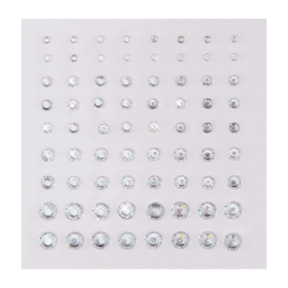 Clear round rhinestone stickers in graduated sizes sparkle on a white backing sheet, arranged in neat rows; ColourPop Crystal Face Jewels, Individual pack, self-adhesive crystals for customizable face and eye makeup looks.