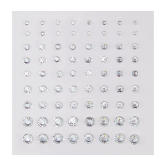 Clear round rhinestone stickers in graduated sizes sparkle on a white backing sheet, arranged in neat rows; ColourPop Crystal Face Jewels, Individual pack, self-adhesive crystals for customizable face and eye makeup looks.