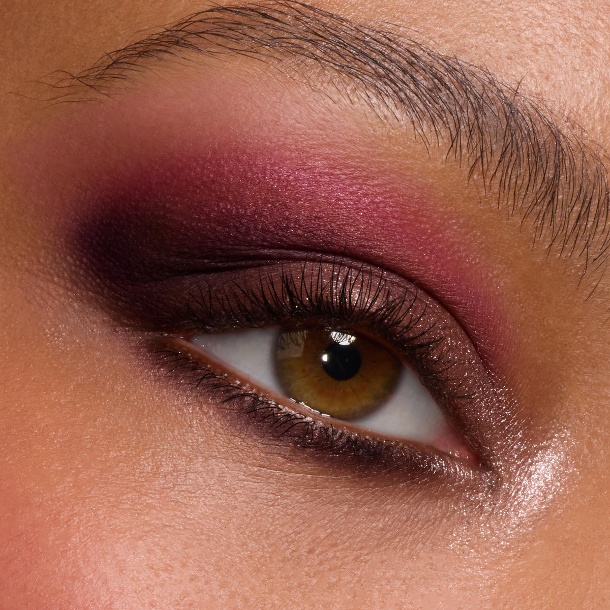 Close-up hazel eye wears a deep berry and plum smoky blend with soft shimmer and inner-corner highlight, created using A Shadow of Secrets Shadow Palette, a ColourPop Shadow Palette, showing bold pigment and smooth blend on lid and lower lash line.