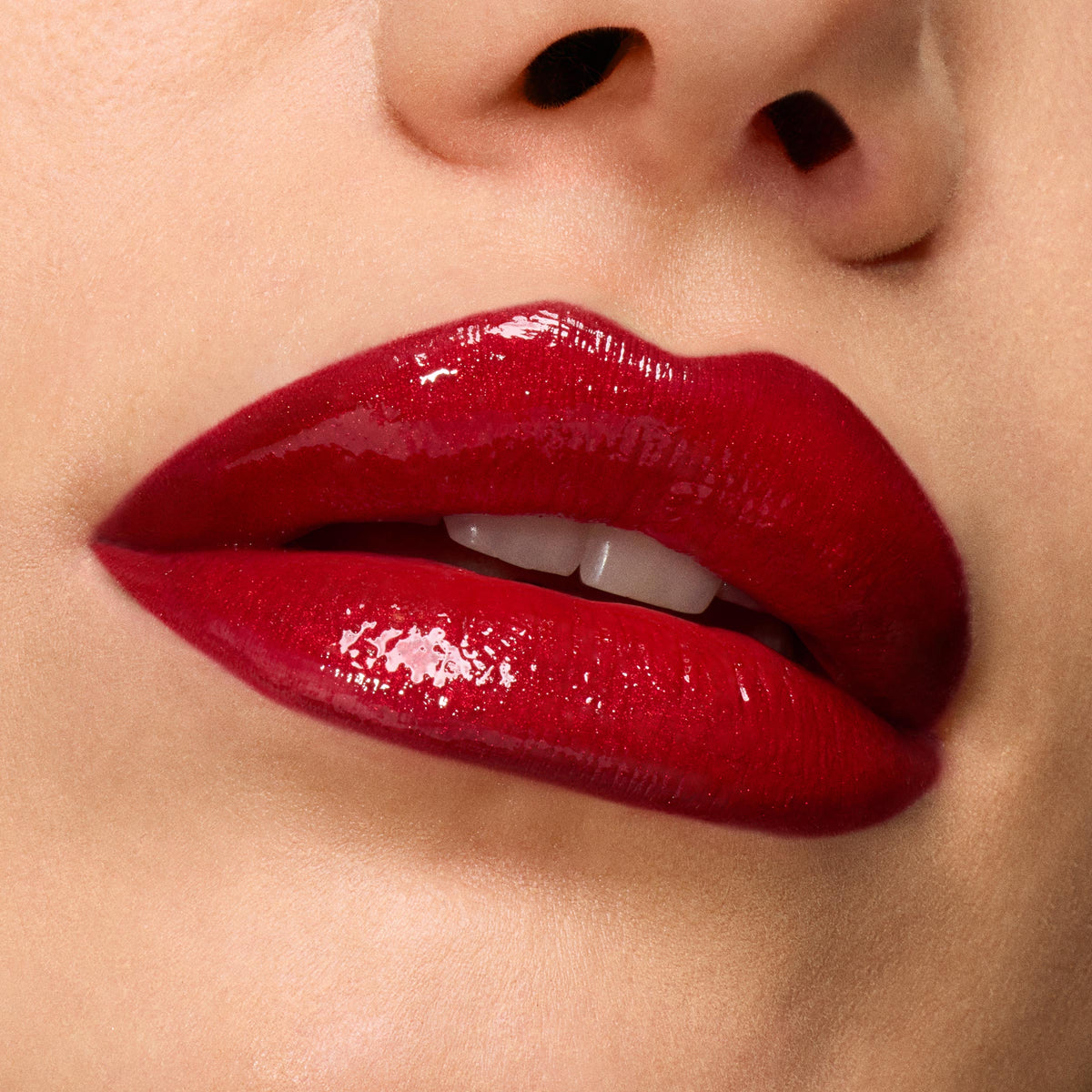 Glossy cherry-red lips showcase Pack Member ColourPop Lip Set, delivering rich pigment and a high-shine finish, captured in an extreme close-up against smooth skin for a bold, vampy look.