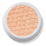 La Mesa ColourPop Super Shock Shadow sits in an open white pot, its warm peachy-champagne shimmer and quilted honeycomb texture catching the light in a close-up top view on a white background.