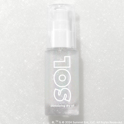 Like Diamonds pump bottle displaying iridescent micro-shimmer through frosted glass with bold white SOL logo, ColourPop SOL Shimmering Dry Oil, standing upright on a silver glitter backdrop that enhances the sparkle for a luminous body glow.