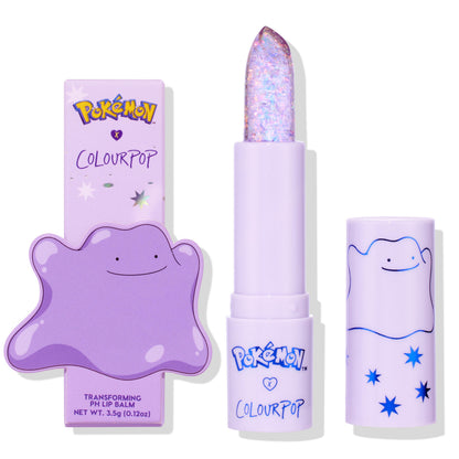 ColourPop pH Lip Balm Transform stands uncapped, revealing an iridescent glitter bullet; a lilac tube and cap with Pokémon Ditto art sit beside the matching box, highlighting the limited-edition packaging in a clean studio shot.