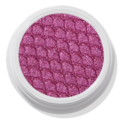 Pug Life ColourPop Super Shock Shadow showcasing a shimmering fuchsia-pink pan with silvery violet sparkle, embossed in a scaled quilt pattern, sitting in an open white single pot against a clean studio white background.