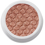ColourPop Sequin Super Shock Shadow shimmers in metallic copper rose-gold as it catches light, pressed with a scale-embossed texture in a white round pot, shown in a clean studio overhead close-up.