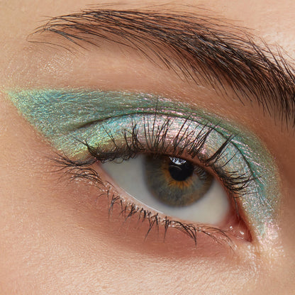 Close-up eye wearing Colourpop Game Over Shadow Stix, showing iridescent teal and pink shimmer eyeshadow blended in a sharp wing across the lid for bold metallic payoff.