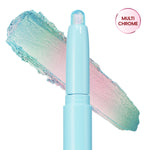 Colourpop Game Over Shadow Stix shown uncapped with a shimmering pastel blue, pink, and green duochrome eyeshadow swatch smeared behind the light blue crayon tube on a white background.