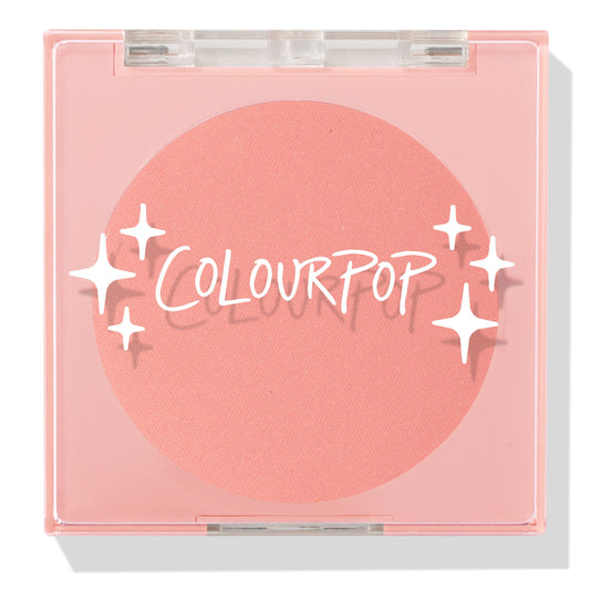 Swirled ColourPop Pressed Powder Blush compact closed, showcasing a warm peach‑coral matte pan beneath a clear pink lid with white starburst logo, square plastic case centered on a white background.