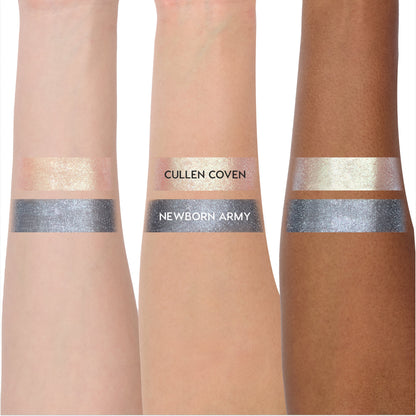 Coven Clash Jelly Much Duo Twilight collection swatched on three arms, showing shimmery pale gold Cullen Coven and metallic steel gray Newborn Army shades with opaque, reflective payoff across light to deep skin tones.
