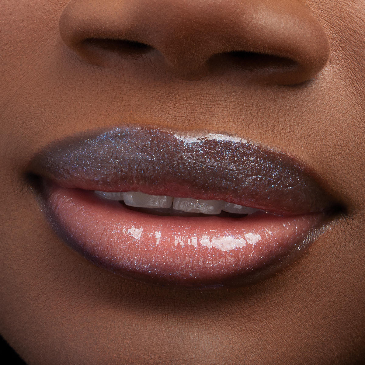 Lips wearing ColourPop Ultra Glossy Lip, Peep This, gleaming with a glassy, high-shine finish and iridescent micro-sparkle; extreme close-up of the mouth highlights smooth, hydrated texture and multidimensional shimmer.