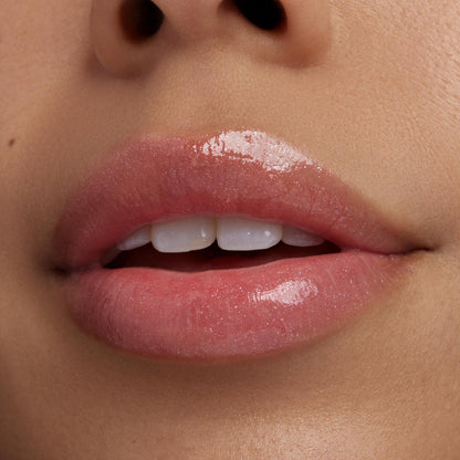 Lips wearing ColourPop Ultra Glossy Lip Yeehaw gleam with sheer pink micro-shimmer, highlighting a smooth, high-shine finish in a macro close-up against natural skin.
