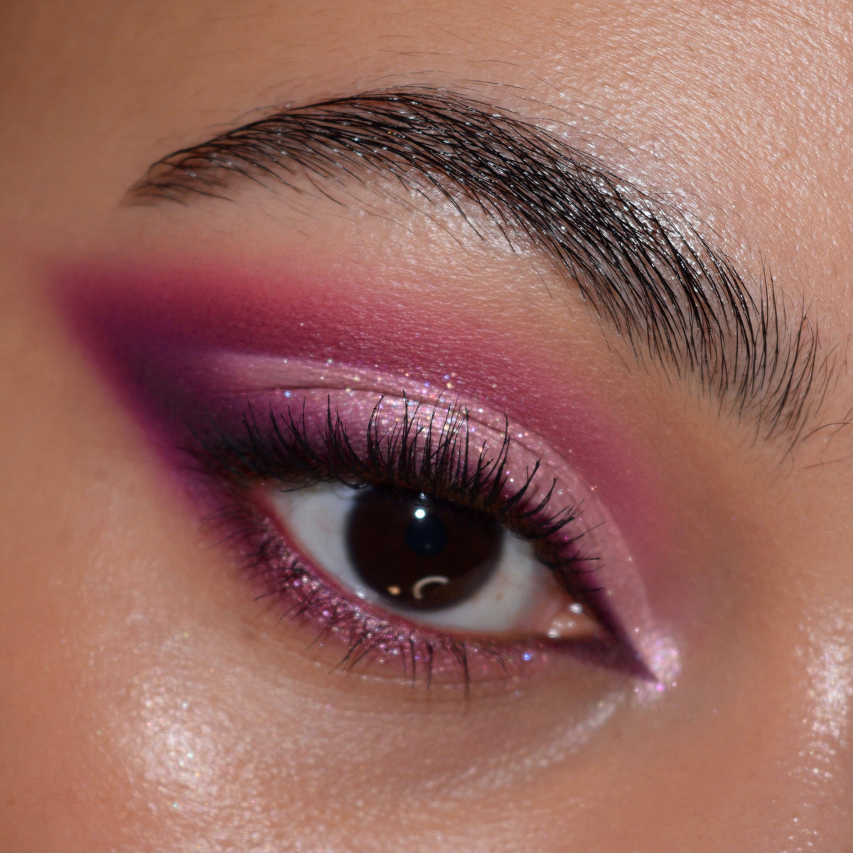 Shimmering pink-to-plum smokey winged eye created with the Total Smokeshow ColourPop Shadow Palette & Brush Set, showing blended metallic and matte shades, crisp inner-corner highlight, fluttery lashes, and a defined brow in close-up studio lighting.