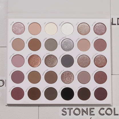 Bold + Bare ColourPop Shadow Palette Set presents an open 30-pan cool‑toned eyeshadow palette with matte and shimmer taupes, mauves, grays, silvers, plum and black, arranged in neat rows on a white tray, lid open on a light textured surface.